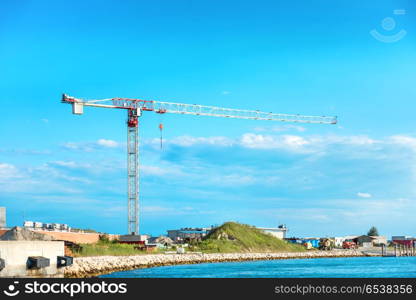 Building crane and building. Building crane and building under constraction on sea island