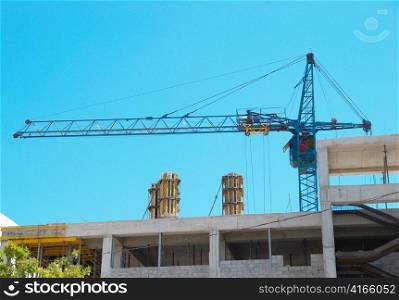 Building crane and the building under construction.