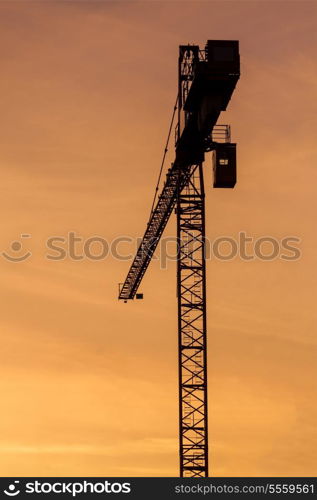 Building crane silhouette in sky on sunset. Munich, Germany