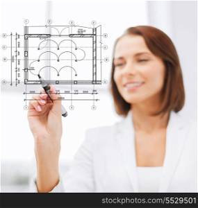 building, developing, consrtuction and architecture concept - female architect drawing blueprint on virtual screen