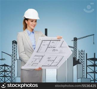 building, developing, consrtuction and architecture concept - friendly young smiling architect in white helmet with blueprints