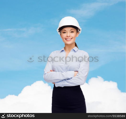 building, developing, consrtuction and architecture concept - friendly young smiling businesswoman in white helmet