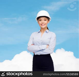 building, developing, consrtuction and architecture concept - friendly young smiling businesswoman in white helmet