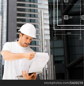 building, developing, consrtuction and architecture concept - male architect in white helmet looking at blueprint