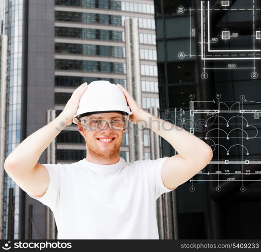 building, developing, consrtuction and architecture concept - male architect in white helmet with safety glasses