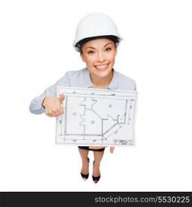 building, developing, consrtuction and architecture concept - smiling businesswoman in white helmet with blueprint showing thumbs up