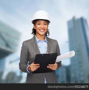 building, developing, consrtuction and architecture concept - smiling businesswoman in white helmet with clipboard and blueprint