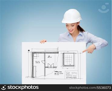 building, developing, consrtuction and architecture concept - young smiling businesswoman in helmet pointing finger to white board