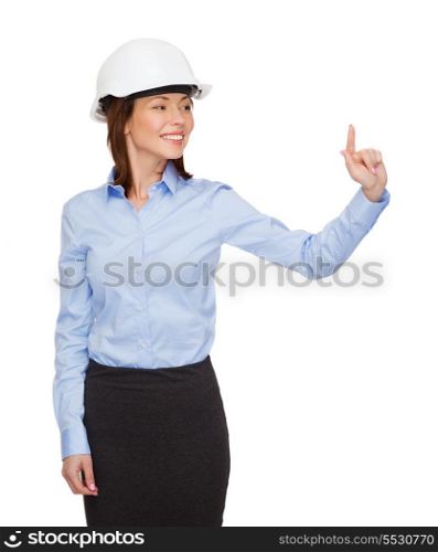 building, developing, consrtuction and architecture concept - young smiling businesswoman in white helmet working with virtual screen