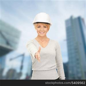 building, developing, consrtuction, architecture concept - female contractor in white helmet ready for handshake