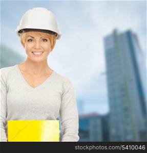 building, developing, consrtuction, architecture concept - female contractor in white helmet with blueprint