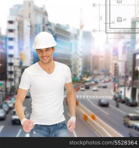 building, developing, consrtuction, architecture concept - handsome builder in white blank t-shirt and helmet