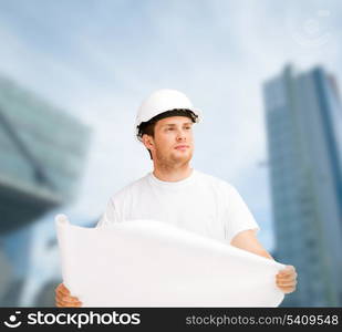 building, developing, consrtuction, architecture concept - male architect in helmet looking at blueprint