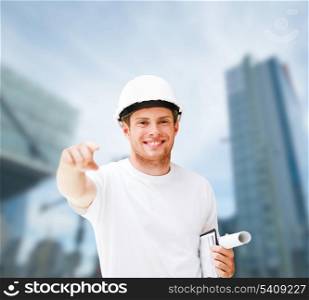 building, developing, consrtuction, architecture concept - picture of male architect in helmet pointing at you