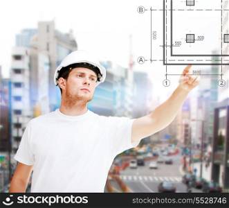 building, developing, construction and architecture concept - concentrated male architect in white t-shirt and helmet pointing to blueprint