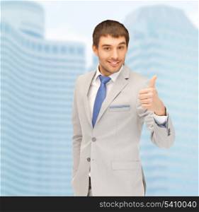 building, developing, construction and architecture concept - handsome man showing thumbs up
