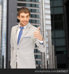 building, developing, construction and architecture concept - handsome man showing thumbs up