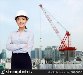 building, developing, construction and architecture concept - smiling businesswoman in white helmet