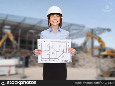 building, developing, construction and architecture concept - smiling businesswoman in white helmet showing blueprint