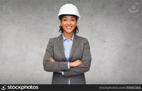 building, developing, construction and architecture concept - smiling businesswoman in white helmet with crossed arms