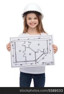 building, developing, construction and architecture concept - smiling little girl in white helmet showing blueprint