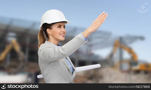 building, developing, construction and architecture concept - smiling woman in white helmet with blueprint