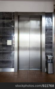 Building Elevator with closed door in apartment complex luxury silver. Building Elevator with closed door in apartment complex luxury