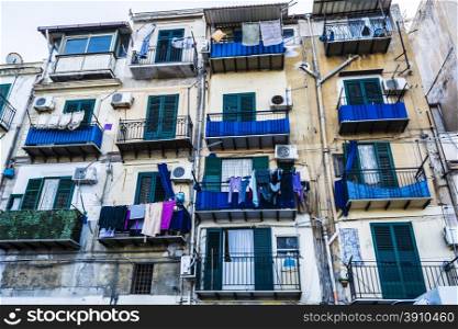 Building exterior with windows and balconies in Palermo, Sicily, Italy