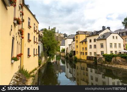 Building facades on river canal in old tourist town on background, Europe. Ancient european city, famous place for travel and tourism, traditional architecture