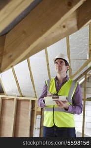 Building Inspector Looking At Roof Of New Property