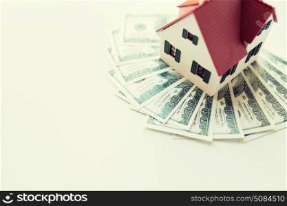 building, mortgage, investment, real estate and property concept - close up of home or house model and money. close up of home or house model and money. close up of home or house model and money