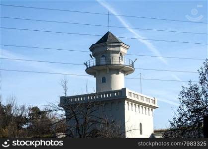 Building of old vintage town water tower on blue sky background