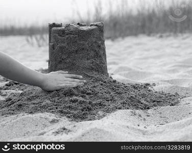 Building sand castle on beach.