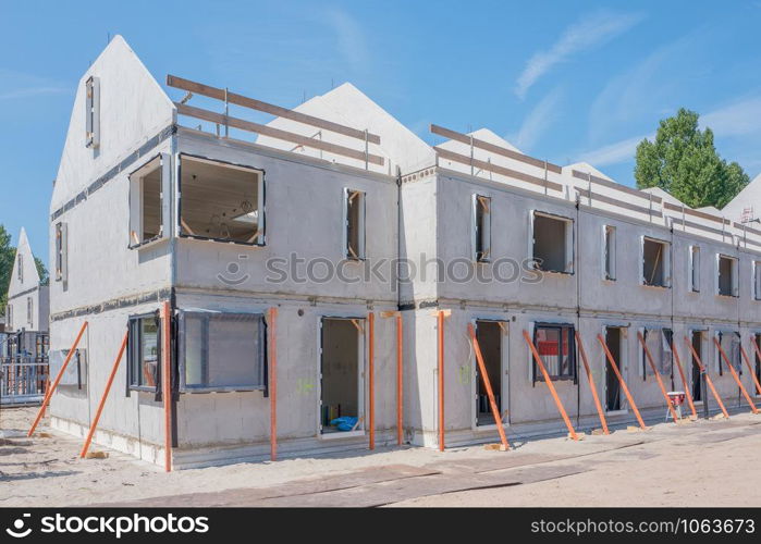 Building site with rows of houses under construction.