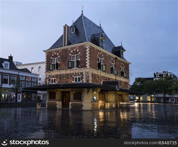building Waag at dusk in the center of old city leeuwarden - cultural capital of Europe in 2018 - in friesland which is a province of the netherlands