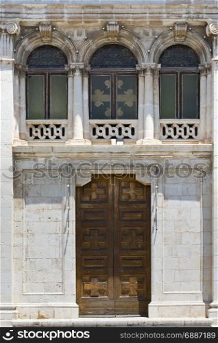 Building with traditional maltese windows and door in historical part of Valletta.