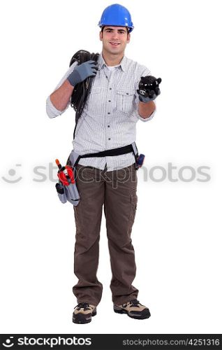 Building worker holding piggy bank on white background