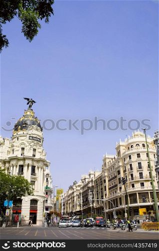 Buildings along a road in a city, Metropolis Building, Madrid, Spain