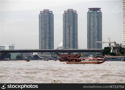 Buildings and bridge on the Chao Phraya river in Bangkok, Thailand