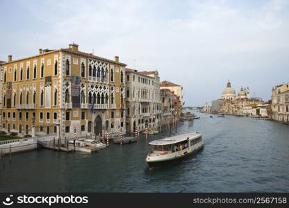 Buildings and cruise boat on canal in Venice, Italy.