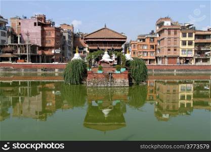 Buildings and pond with green water in Patan, Nepal