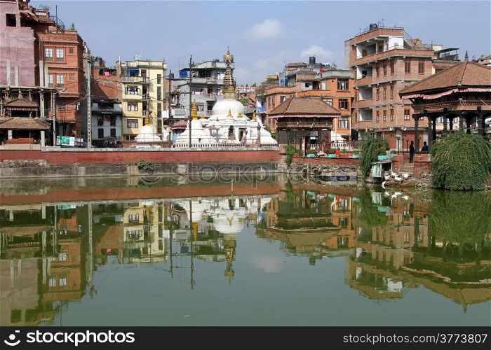 Buildings and stupa near pond in Patan, Nepal