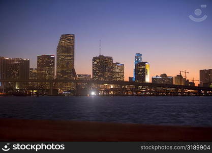 Buildings at the waterfront lit up at dusk, Miami, Florida, USA