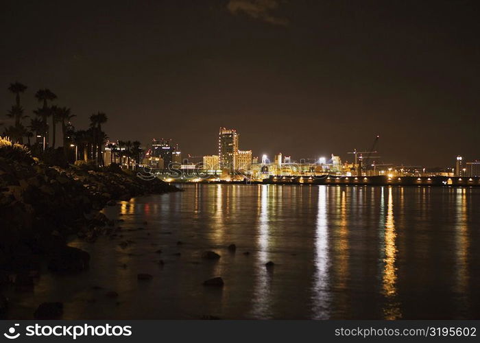 Buildings at the waterfront lit up at night, San Diego, California, USA