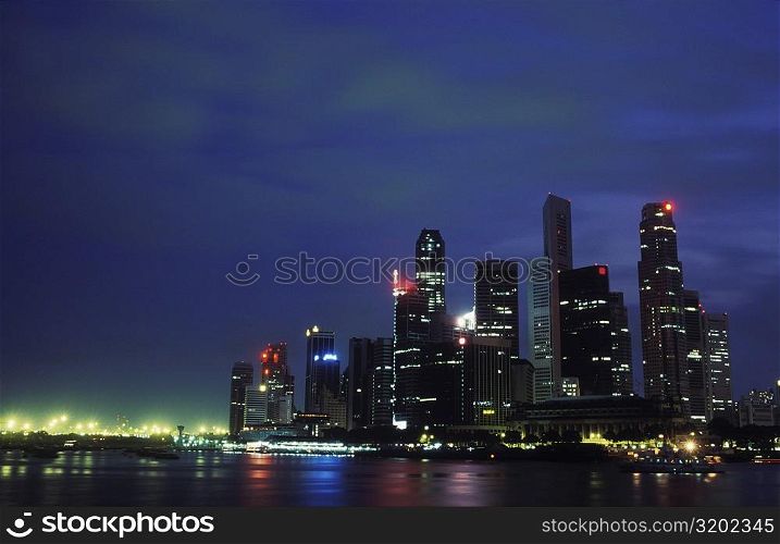 Buildings at the waterfront lit up at night, Singapore