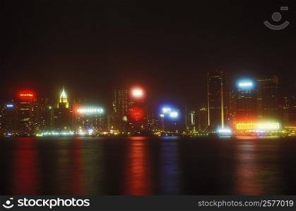 Buildings in a city lit up at night, Hong Kong, China