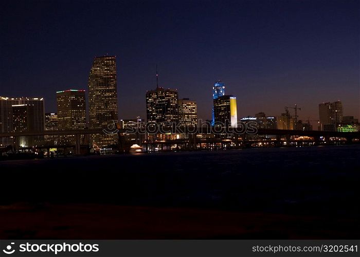 Buildings in a city lit up at night, Miami, Florida, USA