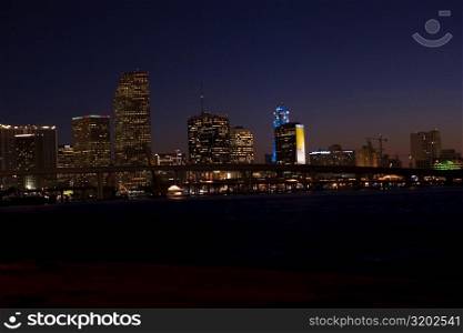 Buildings in a city lit up at night, Miami, Florida, USA