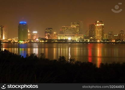 Buildings in a city lit up at night, New Orleans, Louisiana, USA