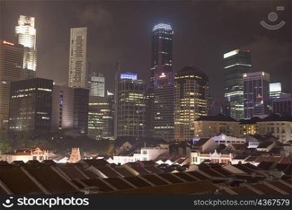 Buildings in a city lit up at night, Singapore